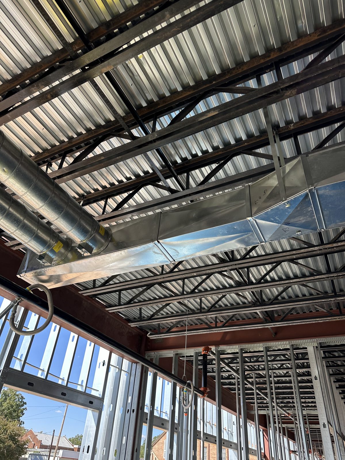Spiral and rectangular galvanized ductwork installed under a steel roof deck